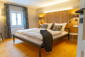 Ein gemütliches Bett mit Kissen und Decken empfängt Sie in der Ferienwohnung im Familienapartment.